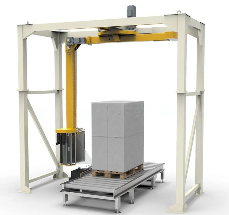Rotary-arm pallet wrapper surrounding a load on a roller conveyor