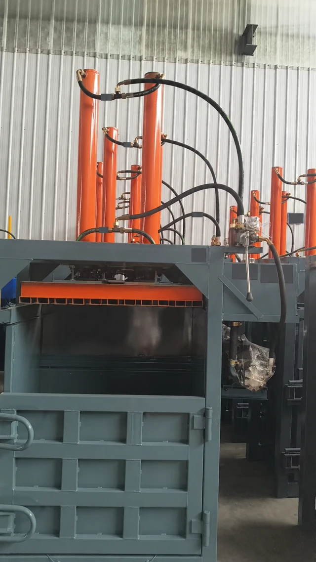 Grey and orange vertical hydraulic baler supplied for the KPW-40T Sri Lanka case, with identifying labels obscured